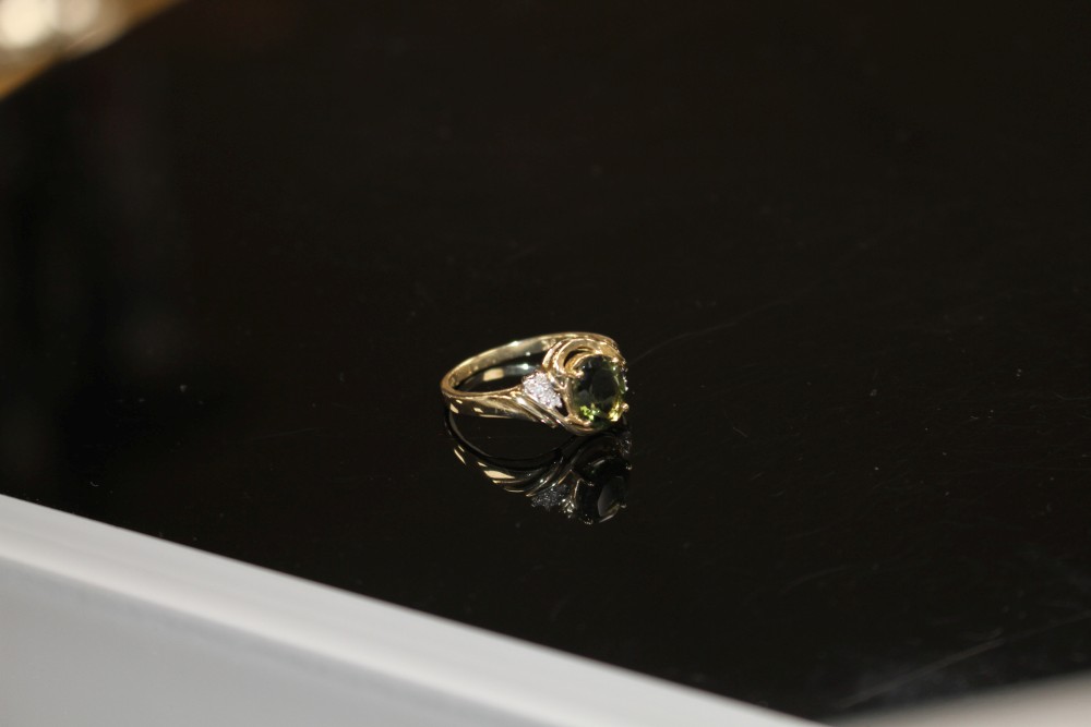 A modern 9ct gold, olive green paste and diamond set dress ring, size S, gross weight 3.2 grams.